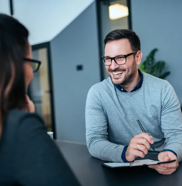 Smiling man having a conversation during a career guidance session at Moving Heads Recruitment Agency